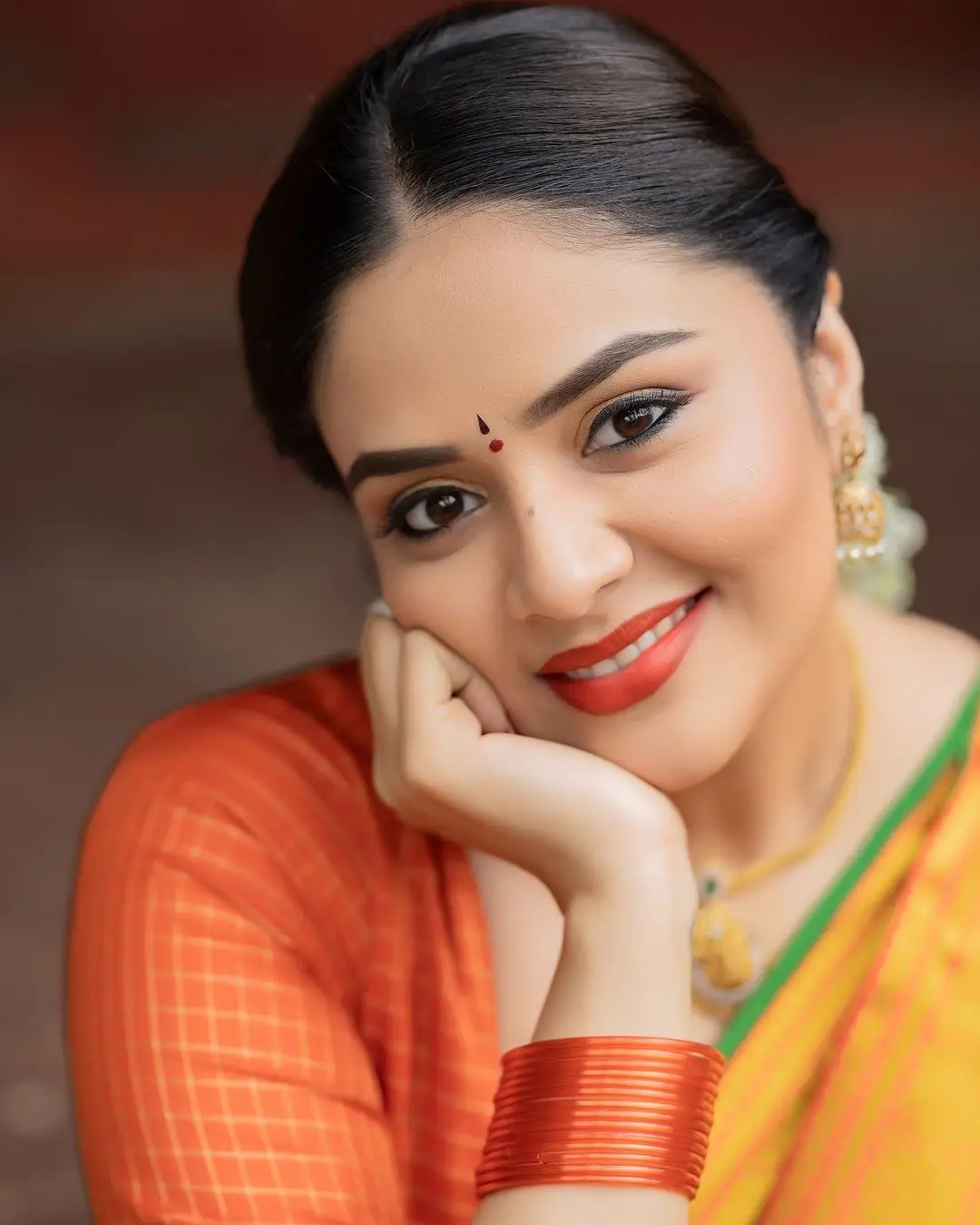 Sreemukhi Stills in Yellow Lehenga Orange Choli Green Voni